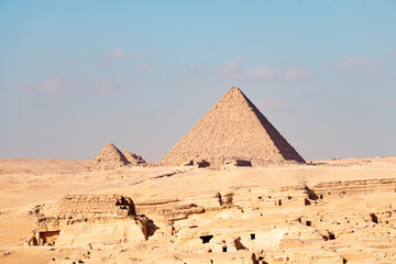 The great pyramid of Mikerina in Cairo, Egypt. Pyramids of Menkaura against blue cloudy sky.