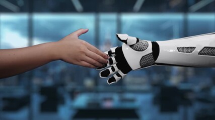 This video depicts a human hand reaching out to a robotic hand, symbolizing the collaboration and interaction between humans and machines in a digital future. Auvana - Powered by Adobe