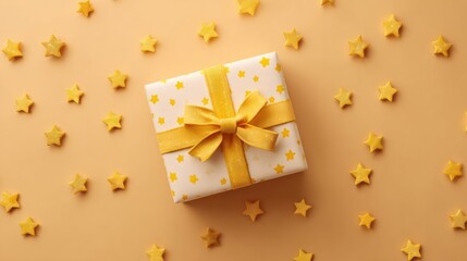 Aerial view of a gift box wrapped with yellow stars and ribbon on a warm background, perfect for festive celebration themes