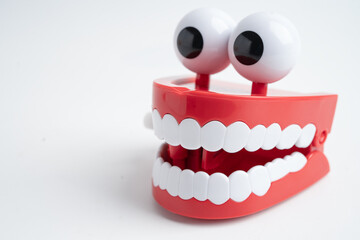 Funny red teeth with eye toy denture model for dental health care.