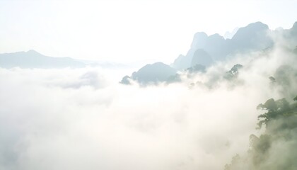 Fototapeta premium A landscape showing mountain peaks emerging through a sea of white mist, serene and tranquil