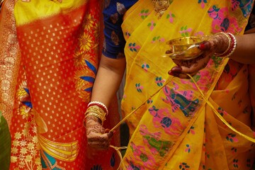 Traditional Bengali wedding gaye holud ritual with turmeric thread