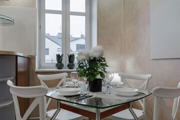 Cozy Dining Area with Glass Table and White Chairs