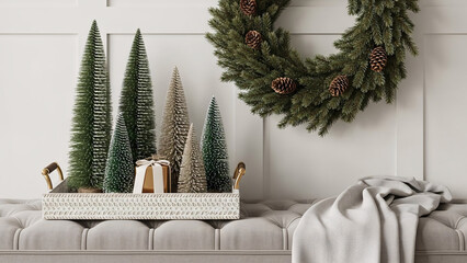 A festive holiday display featuring bottle brush trees in a white tray on a bench, with a Christmas wreath on a paneled wall.