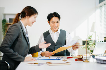 Professional business team discussing documents in a modern office. Collaboration, consulting, and teamwork concept