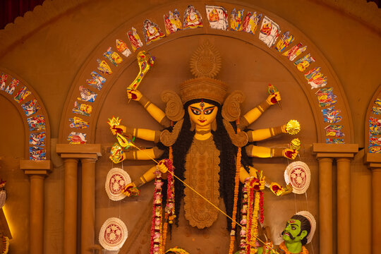 A beautifully crafted handmade colorful goddess durga idol decorated for Navratri, featuring vibrant traditional attire, intricate jewellery, and divine expressions at colorful pandal.