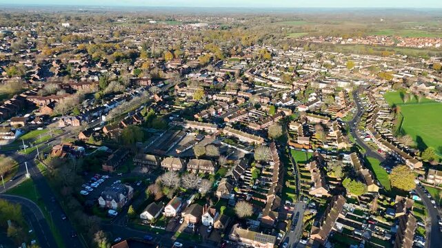 Stunning aerial drone footage showcasing residential neighborhoods in Bracknell, United Kingdom. Beautiful overhead view of suburban houses with streets and green spaces visible.