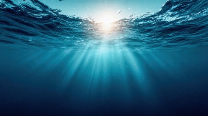 Underwater scene with sunlight streaming through the water's surface.