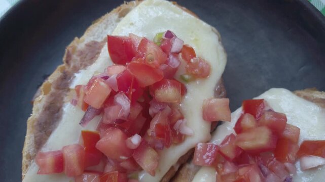 Delicious molletes with melted cheese and fresh salsa topping