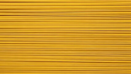 A close up shot showing a dense arrangement of dry spaghetti pasta aligned horizontally in rows