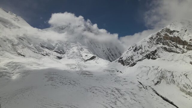 A breathtaking drone view of Manaslu Mountain, rising 8,163 meters in the Nepal Himalaya. The footage captures its towering peaks, dramatic ridges, and pristine high-altitude landscape.