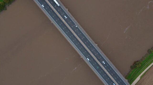 Drone aerial shot of River Trent bridge near Goole Yorkshire UK highlighting motorway highway traffic with cars, trucks and industrial infrastructure transport