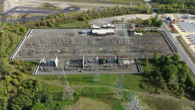 Aerial drone shot of electrical sub station with transformers and pylons in Ferrybridge UK