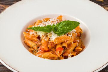 Penne pasta tossed in rich tomato sauce with fresh basil