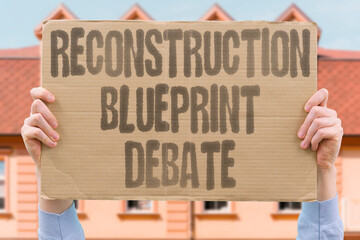 "Reconstruction Blueprint Debate" Rebuilding plans spark international discussions. RECONSTRUCTION. BLUEPRINT. DEBATE. REBUILDING. DISCUSSION.