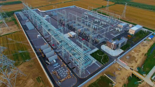 High-Voltage Electrical Substation Commissioning Aerial View with Transmission Towers