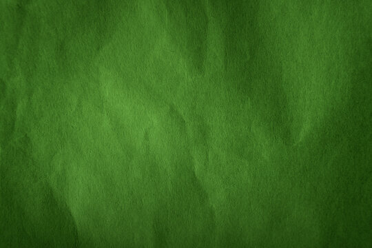 Dark leafy summer green tone color paint on recycled wrap creased paper texture background with space simple style