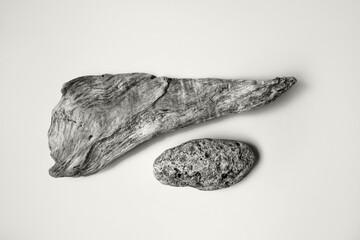 Gray wood and stone on a background. Top view, place for text. Color of the Year 2026, Cloud Dancer.