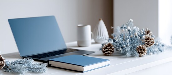 Fototapeta premium Desk with laptop and notebook with minimalist Christmas decoration