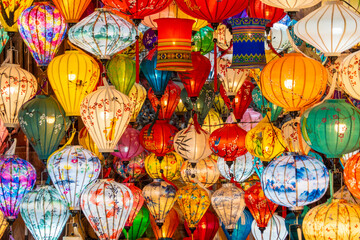 A vibrant display of traditional handmade silk lanterns hanging in the historic old town of Hoi An, Vietnam, during a local market. A symbol of Vietnamese culture, light, and tradition. © Daniel Ferryanto