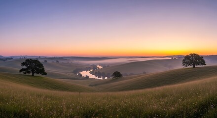 Gentle rolling hills meet a winding river at sunrise under a clear sky.