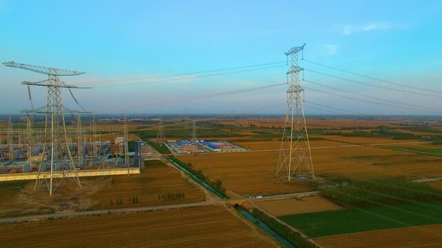 High Voltage Transmission Towers Over Agricultural Farmland