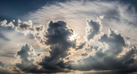 Sunbeams break through dramatic, dark, and light clouds.