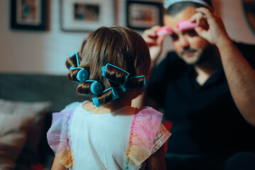 Little Girl with Hair Curlers Playing Dress up with Dad. Daughter and father spending quality time together