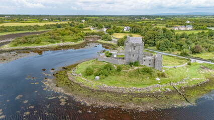 Aerial drone view of Dunguaire Castle, a 16th century tower house top view from above, historical castle in Galway Bay, Ireland
