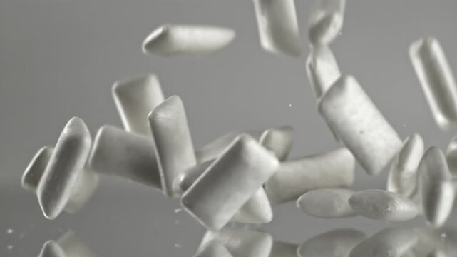 Chewing gum falls on the table. Filmed on a high-speed camera at 1000 fps. High quality FullHD footage
