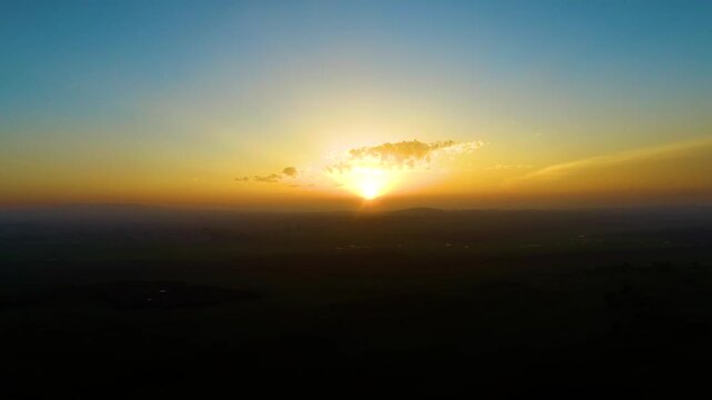 Golden Sunrise Over Landscape with Dramatic Sky