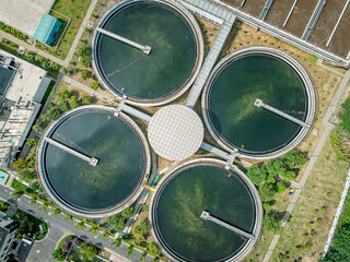 Aerial top view of circular sedimentation tanks in modern water treatment plant facility.