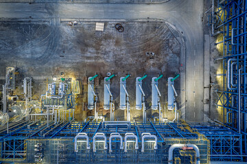 Aerial top down view of pipeline equipment in chemical factory industrial area.