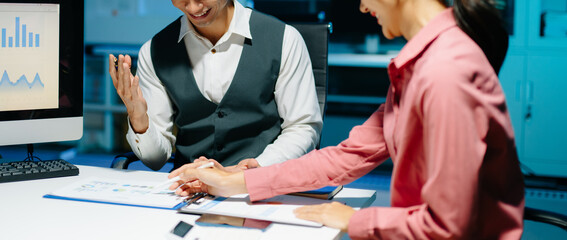 Professional coworkers discussing data and analyzing business reports in a modern office of teamwork, strategy, and corporate collaboration.