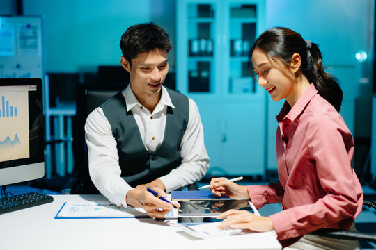 Professional coworkers discussing data and analyzing business reports in a modern office of teamwork, strategy, and corporate collaboration.