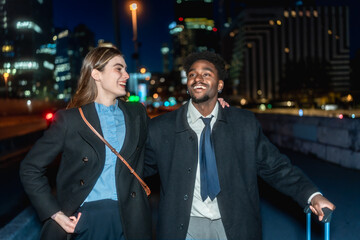 Diverse business people traveling in city at night