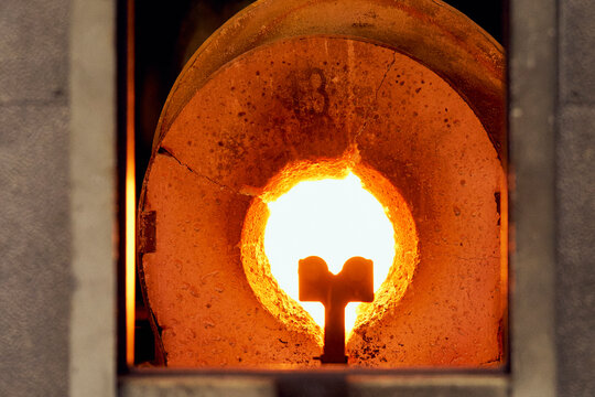 Flame in round opening of hot glassblowing furnace
