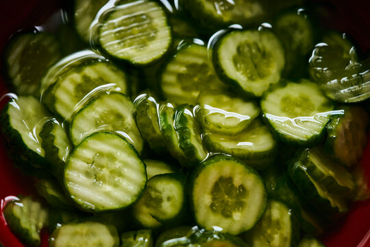 Still life view from above of crinkle cut sliced cucumbers in cucumber salad
