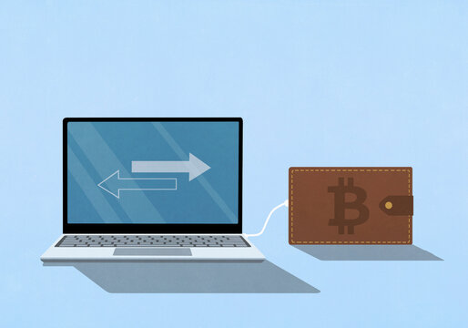 Bitcoin digital wallet plugged into a laptop with arrows on screen
