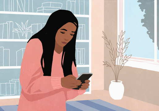 Woman texting with smart phone at home in living room
