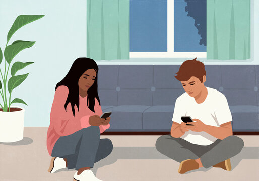 Multiracial couple using smart phones at living room sofa at night
