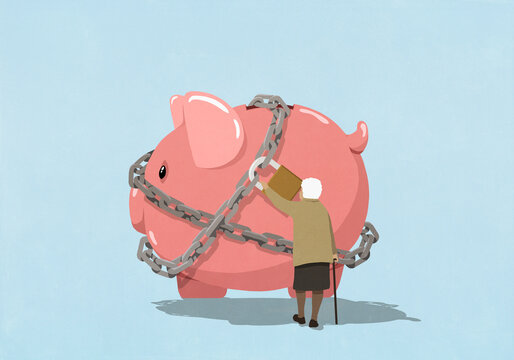 Senior woman checking padlock on large piggy bank against blue background
