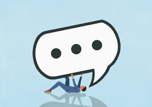 Large speech bubble with dot dot dot symbol on top of overwhelmed businessman
