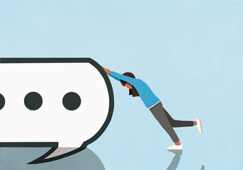 Girl pushing large text message speech bubble against blue background
