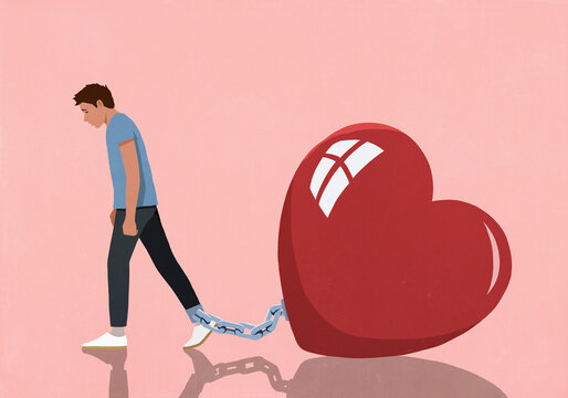 Large red heart shackled to ankle of dejected man on pink background
