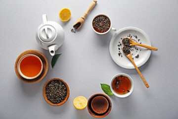 Frame made of tea pot, cups of tea and lemon on white background