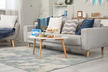Interior of festive living room with grey sofa and decorations for Hanukkah celebration