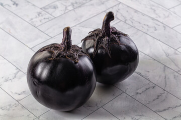 Raw round black big eggplant