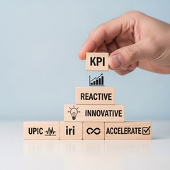 Hand stacking wooden blocks with business growth concepts like kpi reactive innovative and accelerate building a pyramid for strategic planning and success