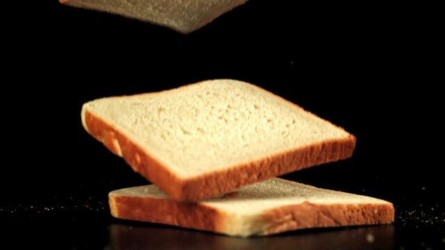 Pieces of bread fall on the table. Filmed on a high-speed camera at 1000 fps. High quality FullHD footage